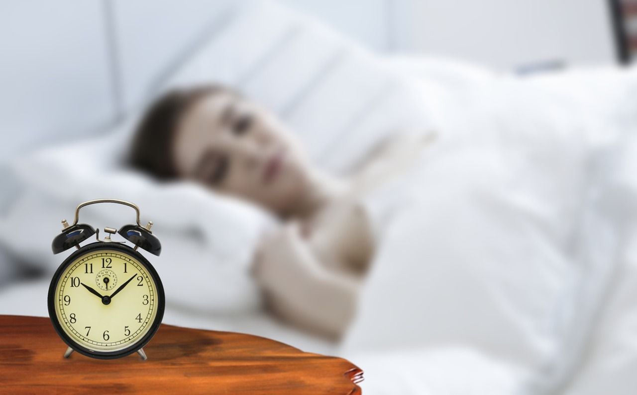 Alarm clock and person sleeping